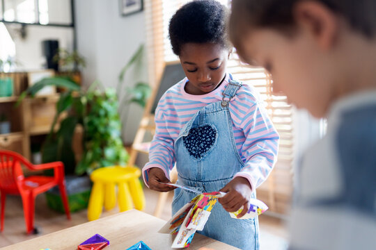 Diverse children playing with educational crafts in school