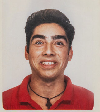 Playful photobooth portrait of teenage boy in the 1990s