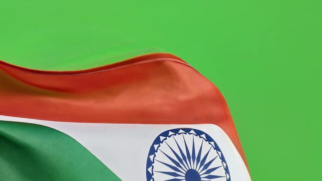 Close-up of the Indian flag waving against a green background