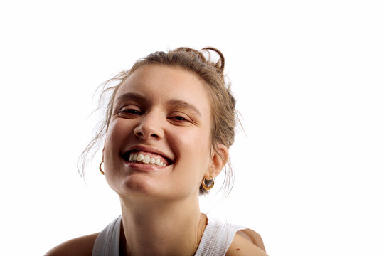 Woman smiles in front of a camera
