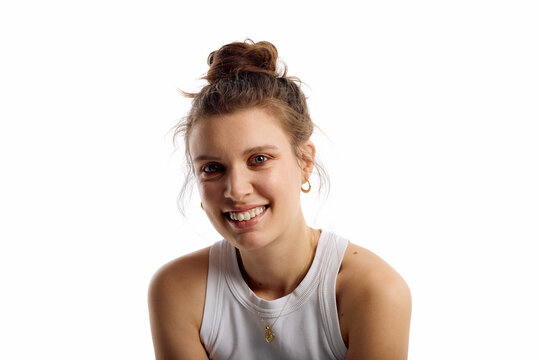 Woman smiles front of a white background