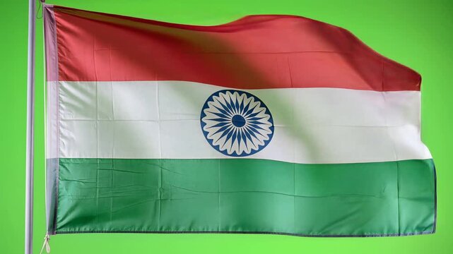 The Indian flag waving on a pole against a vibrant green background