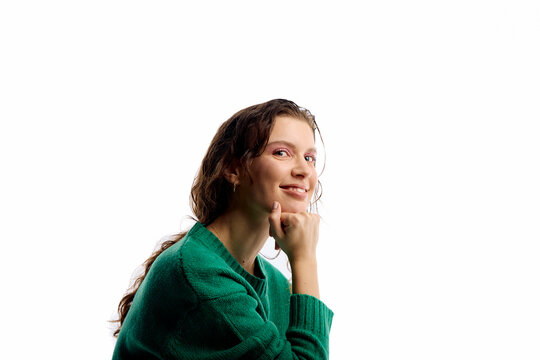 A joyful woman poses against a white backdrop.