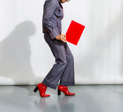 Person in Stylish Outfit and Red Shoes