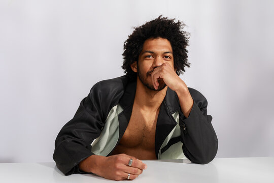 Stylish Man Posing at a Table
