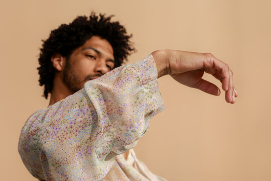 Man Posing With Arm Extended in Studio 