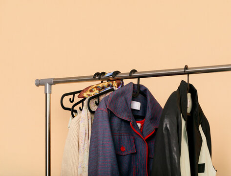 Hanging Clothes on a Rack in a Simple Indoor Space