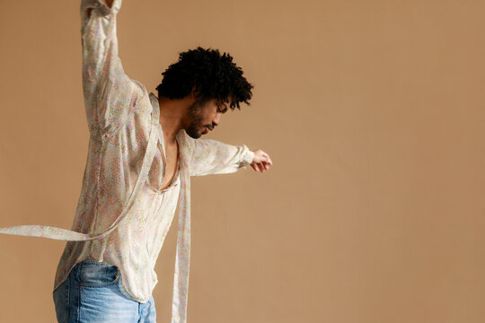 Dancer Moves Gracefully With Arms Extended in Studio Space