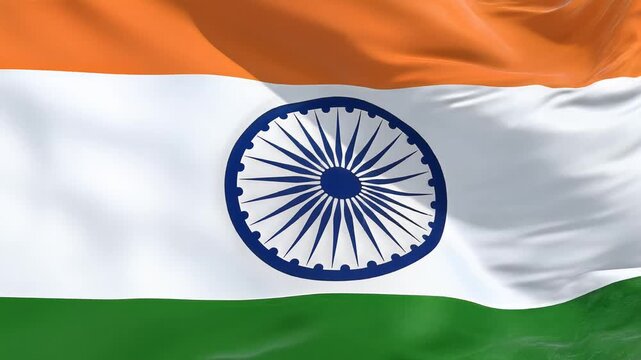 The flag of India waving with vibrant orange, white, and green colors.