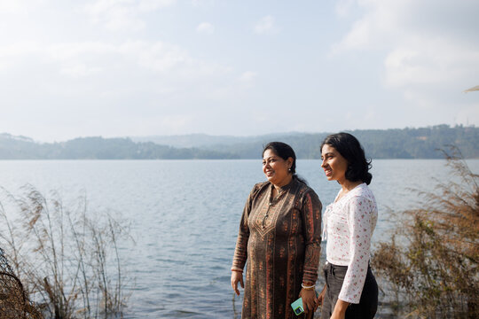 Mother and daughter Enjoy Time Near the Lake on a Sunny Day