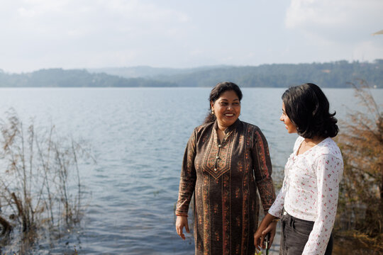 Mother and daughter Enjoy Time Near the Lake on a Sunny Day