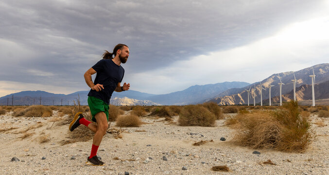 Fit Athlete trail running motion in desert