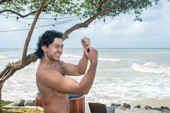 Man Enjoys a Moment by the Beach Under a Cloudy Sky