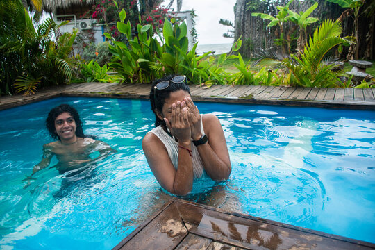 Two Friends Have Fun in a Swimming Pool
