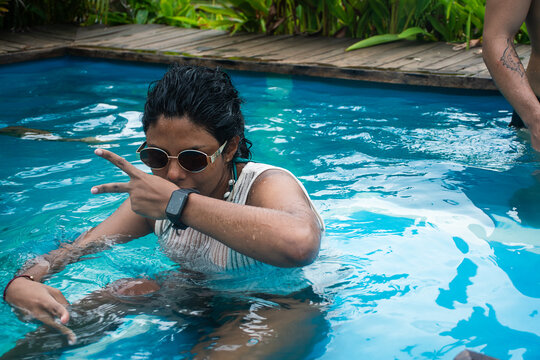 Young Person Enjoys Time in the Water at a Pool During Summer