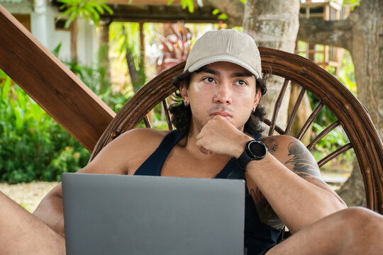 Young Man Working on Laptop in Outdoor Setting During Daytime