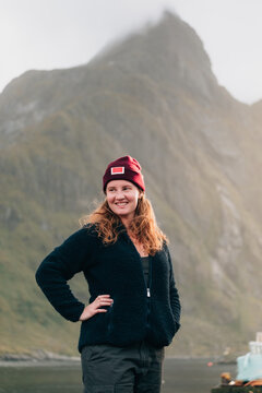Woman smiling in front of a mountain in Lofoten, Norway