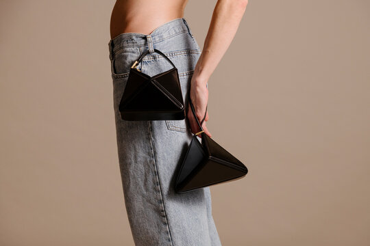 Minimal Black Triangle Handbags With Denim Jeans