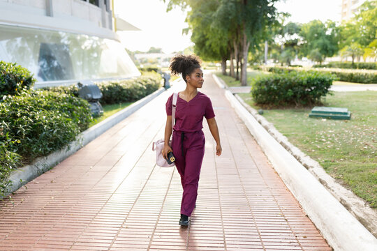 Health Worker Walks in Park During Afternoon Hours