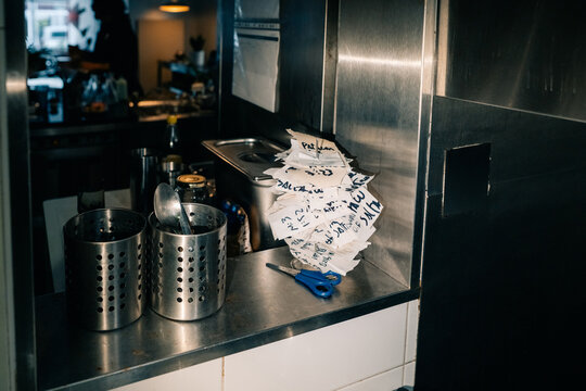 Kitchen Scene Shows Orders on Tickets in Small Restaurant