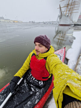 Portrait of a Young Adventurer Winter Kayaking in Icy Harbor