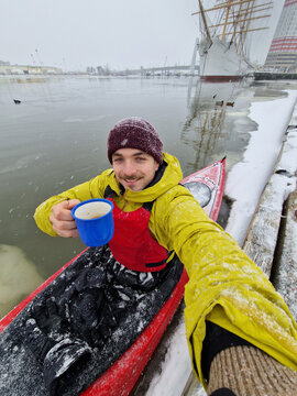Man Enjoying Hot Drink During Winter Kayaking Trip