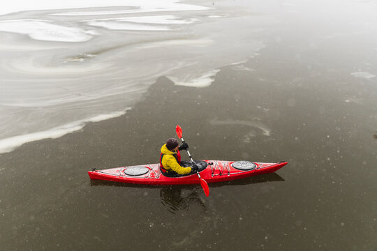 Top View of Red Kayak Navigating Icy Dark Ocean Waters
