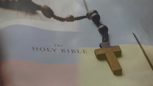 BIBLE page with cross and rosary resting, camera and light sweeping, highlighting religious text