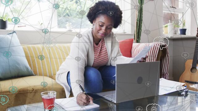 Woman holding paper glancing laptop and taking notes to crosscheck edtech overlay over her