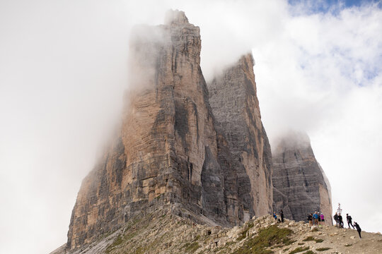 Hikers explore the mountain trail under the Italian landmark Tre Cime