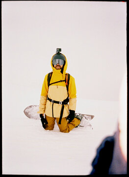 Man with snowboard takes a break 