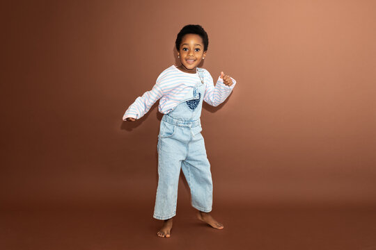 Happy black girl dancing in studio