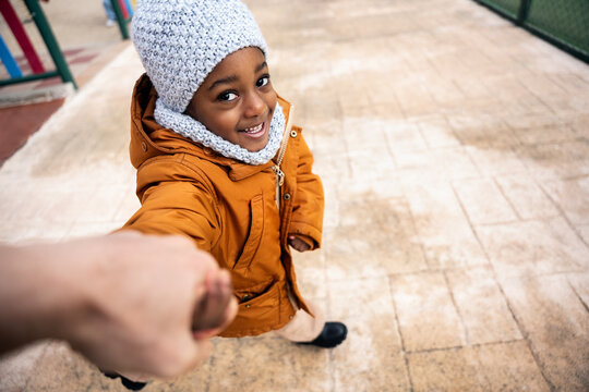 Little black child holding hand smiling at camera