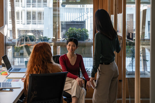 Team meeting in a modern office space with laptops