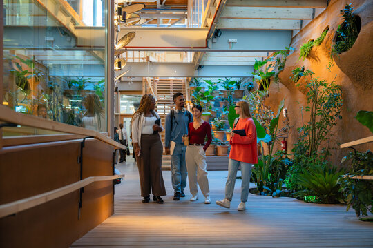 Diverse group walking in modern indoor garden