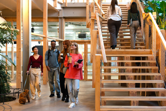 Coworkers mingling in an open workspace with modern design