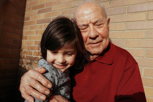 Grandfather and Granddaughter hug together