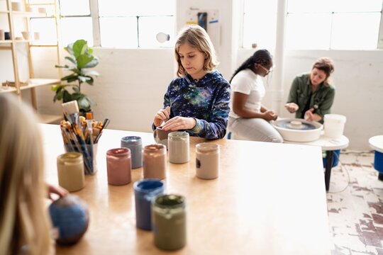 Kid working with clay in ceramics class