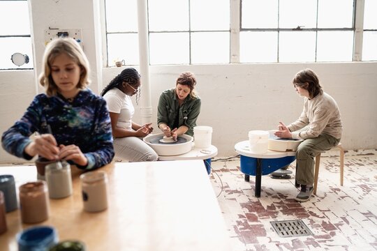 Kids learning pottery in ceramics studio