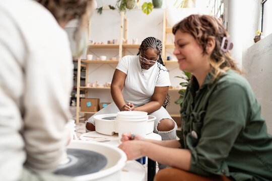 Teens learning pottery in ceramics studio