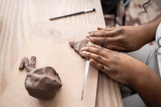 Student Shaping Clay by Hand