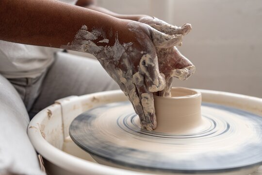 Student Shaping Clay on Pottery Wheel