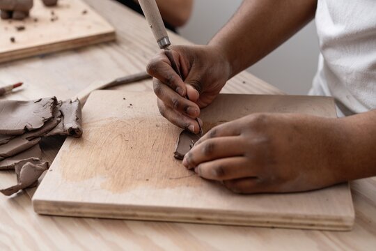 Student Carving Clay with Sculpting Tool