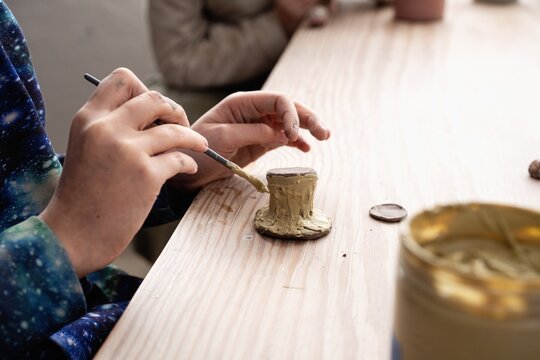 Child Painting Small Clay Sculpture