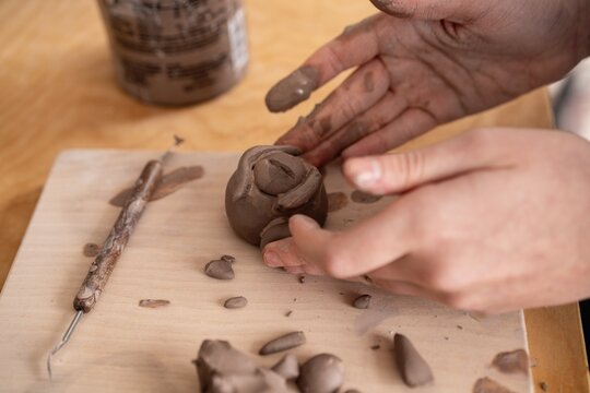Hands Shaping Clay Sculpture