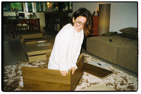 Woman Assembling Furniture Happily