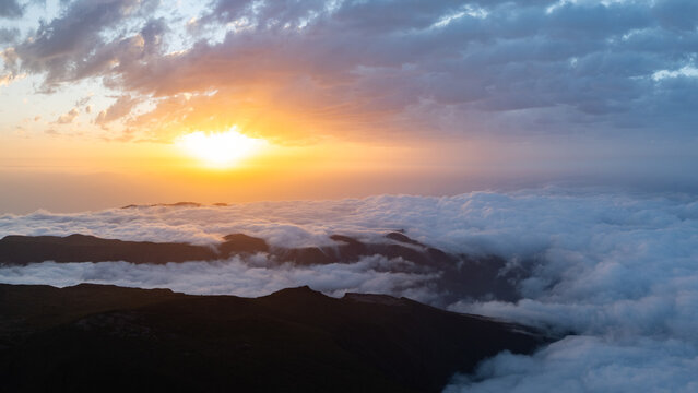 Aerial view of the Bica da Cana viewpoint at sunset with a thick sea of clouds covering the mountain peaks under a dramatic sky Ponta do Sol, Madeira, Portugal.