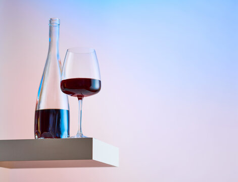 Glass of Red Wine and Bottle on Levitated Surface 