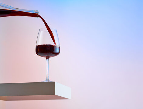 Pouring Glass of Red Wine on Levitated Surface 