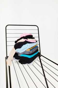 Colourful laundry clothes on a drying rack with direct flashlight